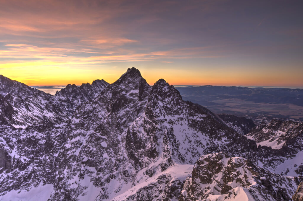 Snow-capped alpine mountains at sunrise with warm pink and gold sky in winter landscape wallpaper