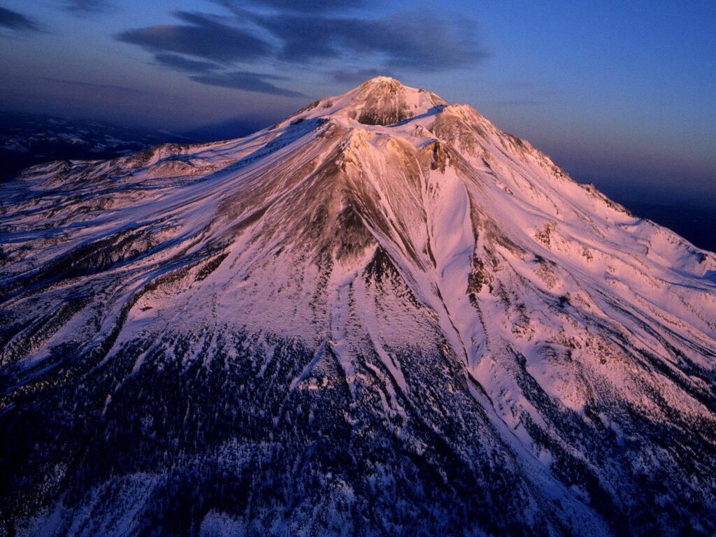 Snow-covered California volcano at sunset with serene peak and rugged mountain terrain wallpaper