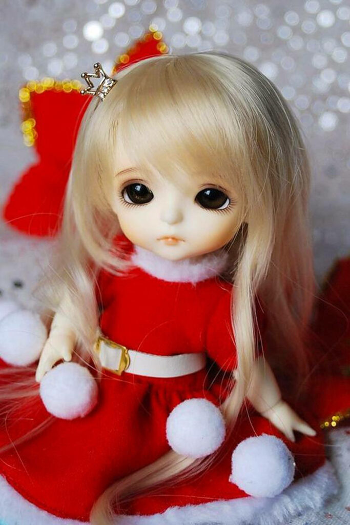 A Snowy Delight: A Enchanting Doll in a Vibrant Red Dress, Surrounded by Glistening Snowballs Wallpaper