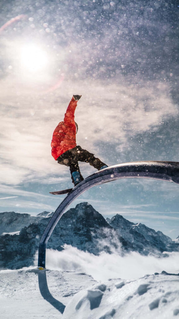 Snowboarder Trick Wallpaper: Stunning Mountain & Sun Background