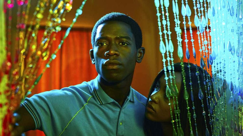 Snowfall wallpaper with Franklin Saint and Veronique Turner in dramatic warm gold and blue light