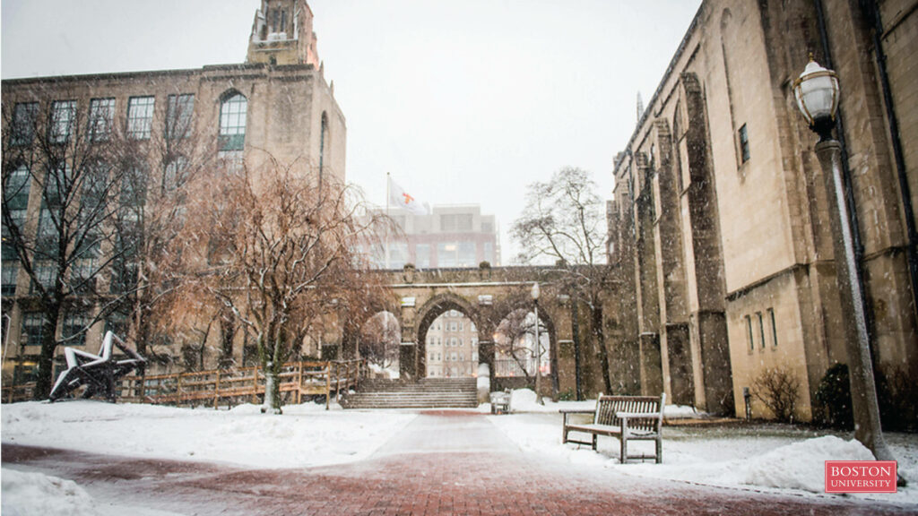 Snowy Boston University campus with red brick paths stone archways and wintry trees in high resolution Wallpaper