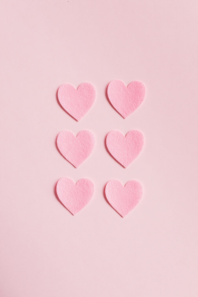 Minimalist Soft Pink Hearts Wallpaper on Pastel Pink Background