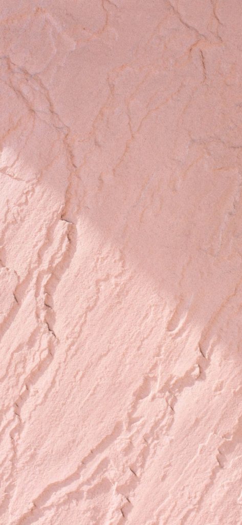 Soft pink natural stone texture wallpaper with soft ambient light for modern backgrounds