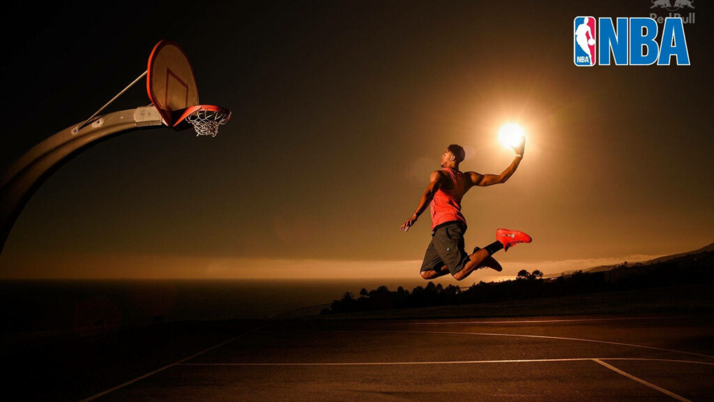 Dunking the Sun: Epic HD Background of a Basketball Star Soaring towards the Hoop Wallpaper