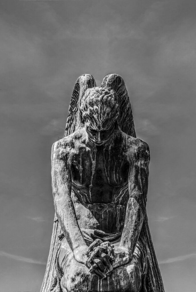 Solemn Angel Statue Wallpaper: Serenity in Black & White Background