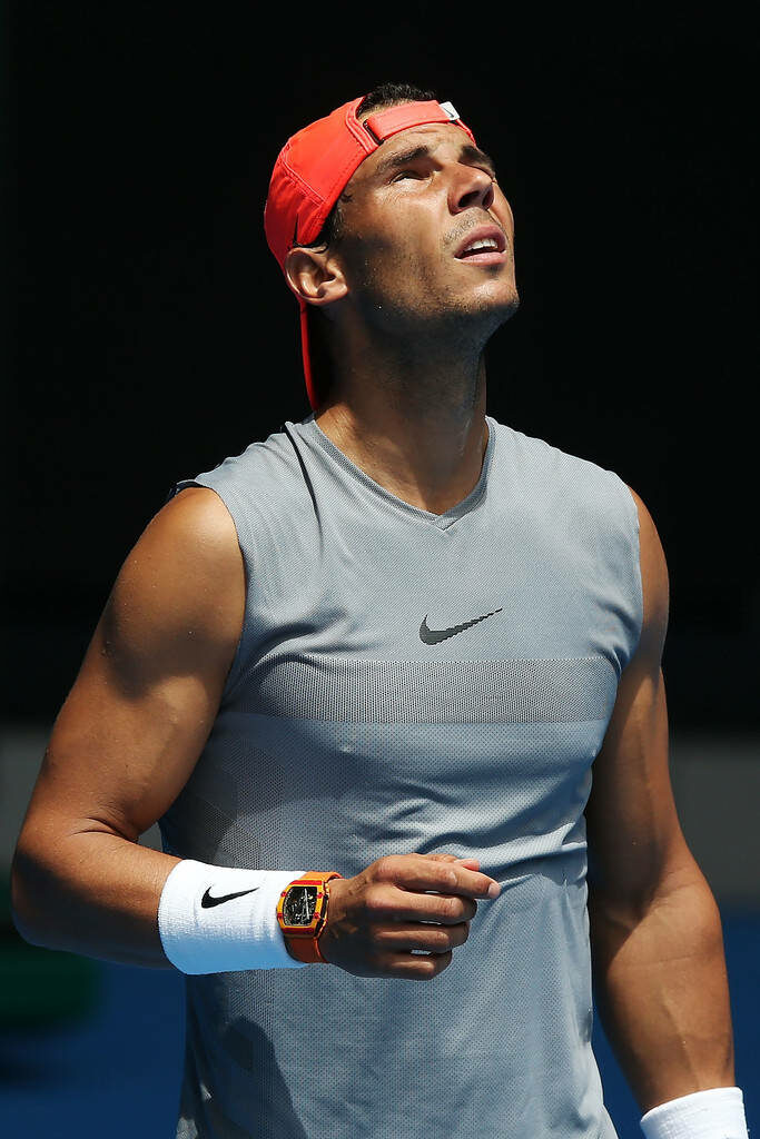 Rafael Nadal: Focused Tennis Star in Gray Nike Tank - Wallpaper
