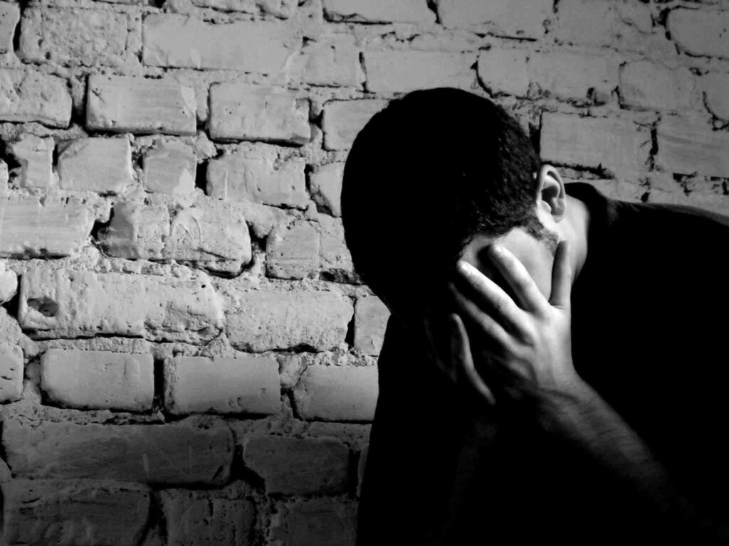 Solitary Boy in Grayscale: Introspective Wallpaper Background