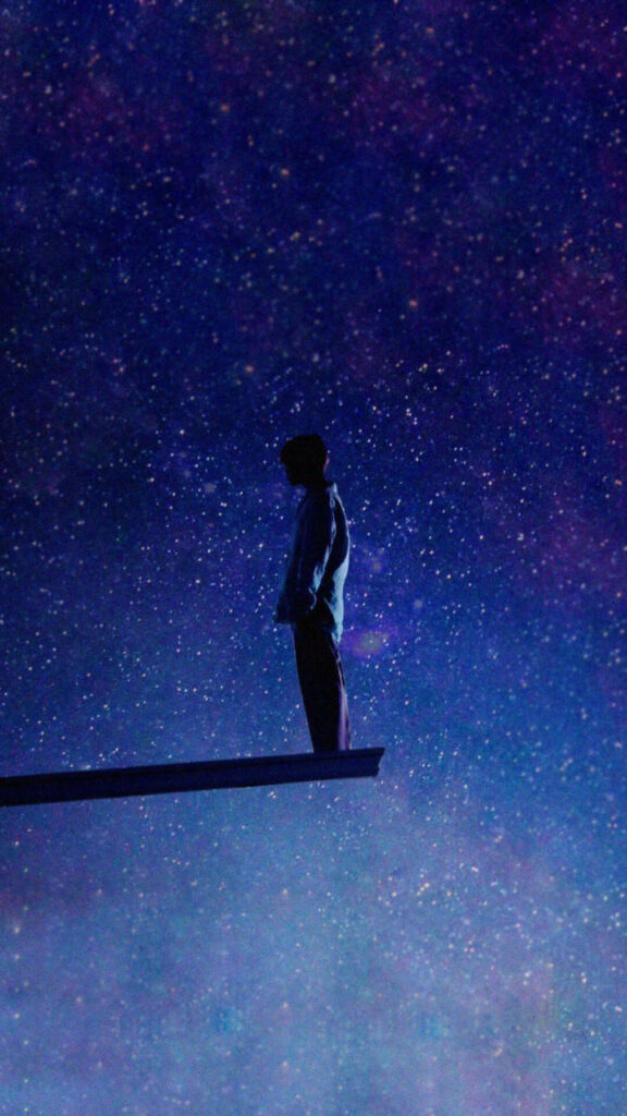 Solitary Figure: A BTS Galaxy Journey Through Space and Shadows Wallpaper