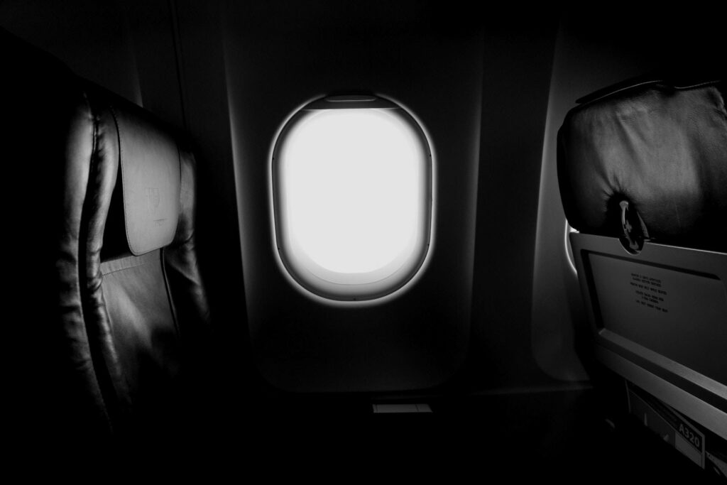 Solitude in the Sky: 1920x1080 HD Dark Plane Window Wallpaper