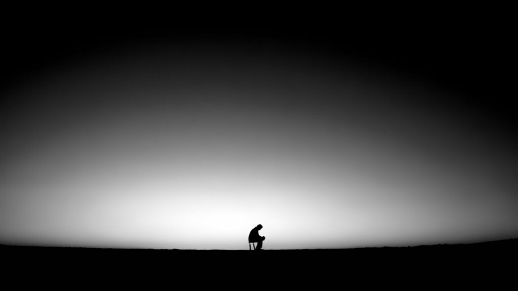Solitude in Minimalism: A QHD Wallpaper Illustration of An Abandoned Figure Sitting Alone on a Chair