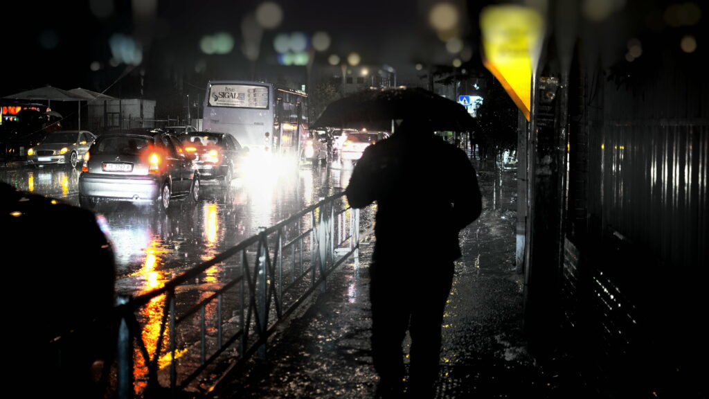 The Solitary Soaker: A Enchanting Night of Solitude in the Rain Wallpaper