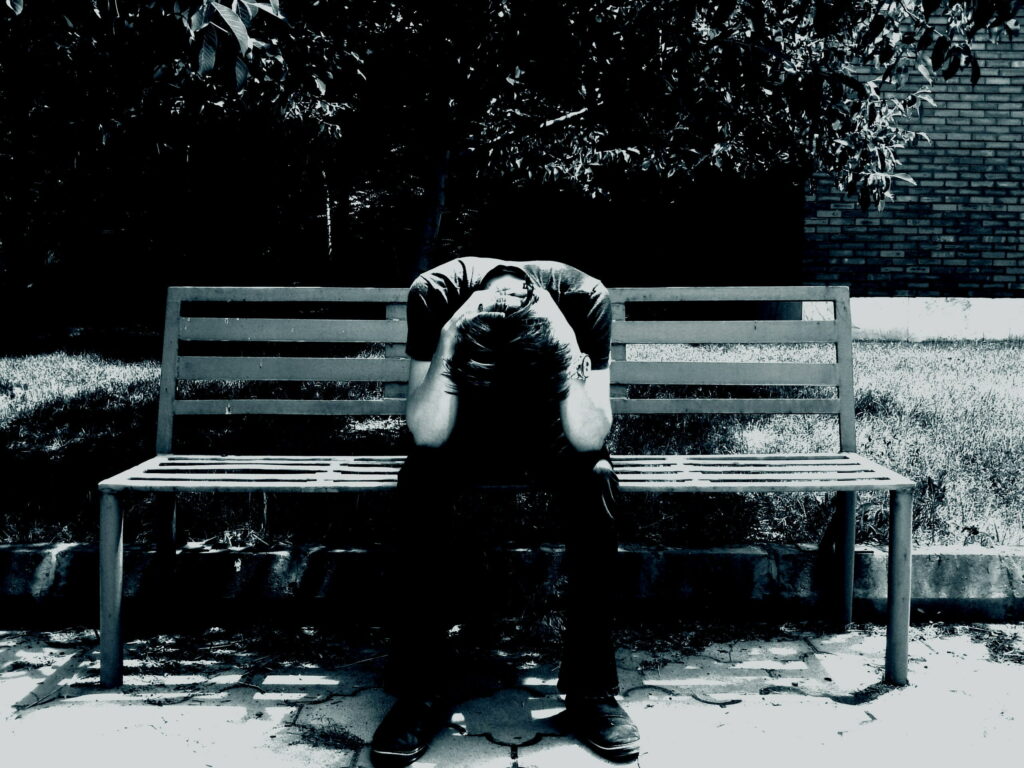 Solitude's Symphony: Capturing the Emotions of a Lone Man on a Bench Wallpaper