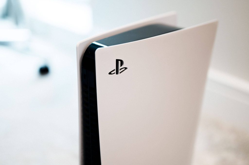 Close-up of Sony PlayStation 5 console white side plate black core with PlayStation logo Wallpaper