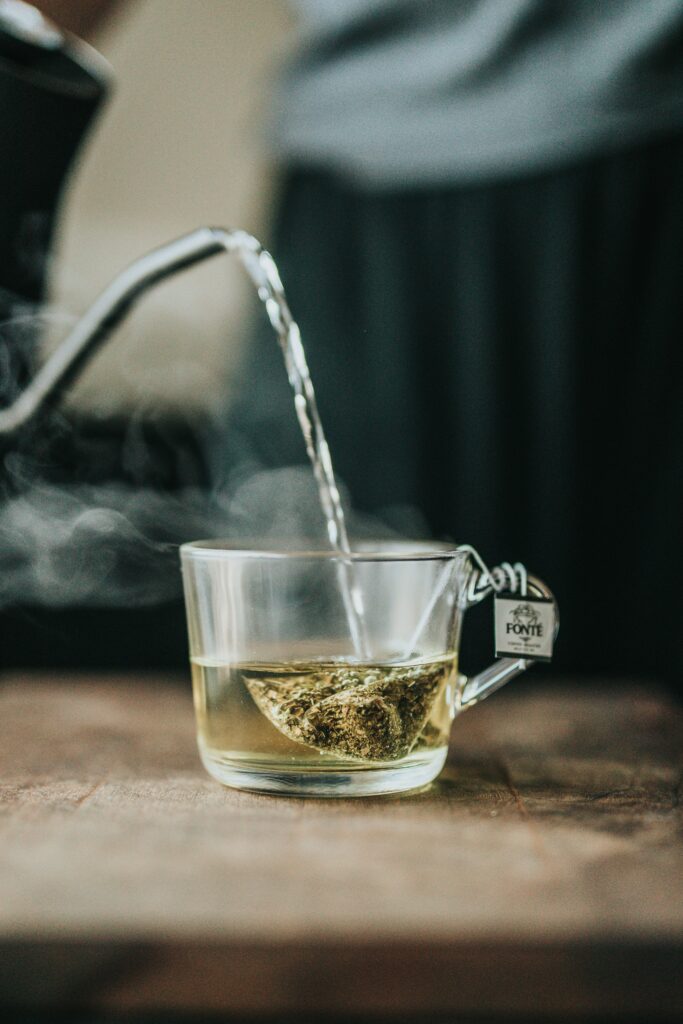 Relaxing Hot Tea Pour: Aromatic Steam Wallpaper Background