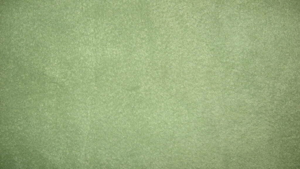 Sage green minimalist textured wallpaper with soft organic paint stain effect for desktop display