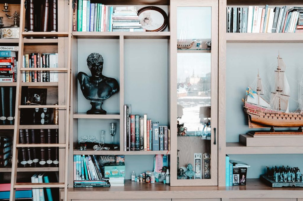 Sophisticated Zoom background with wooden library wall black bust sailing ship and bookshelves Wallpaper