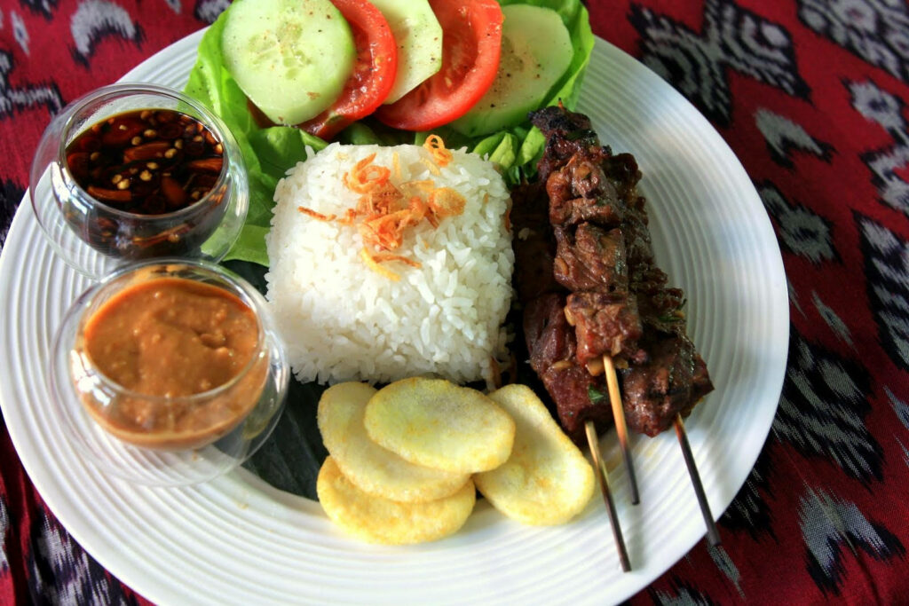 Vibrant Southeast Asian Dish Wallpaper: Satay, Rice & Peanut Sauce