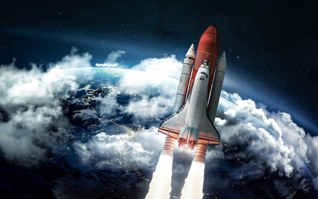 Space Shuttle launching above Earth with clouds glowing in high definition space wallpaper