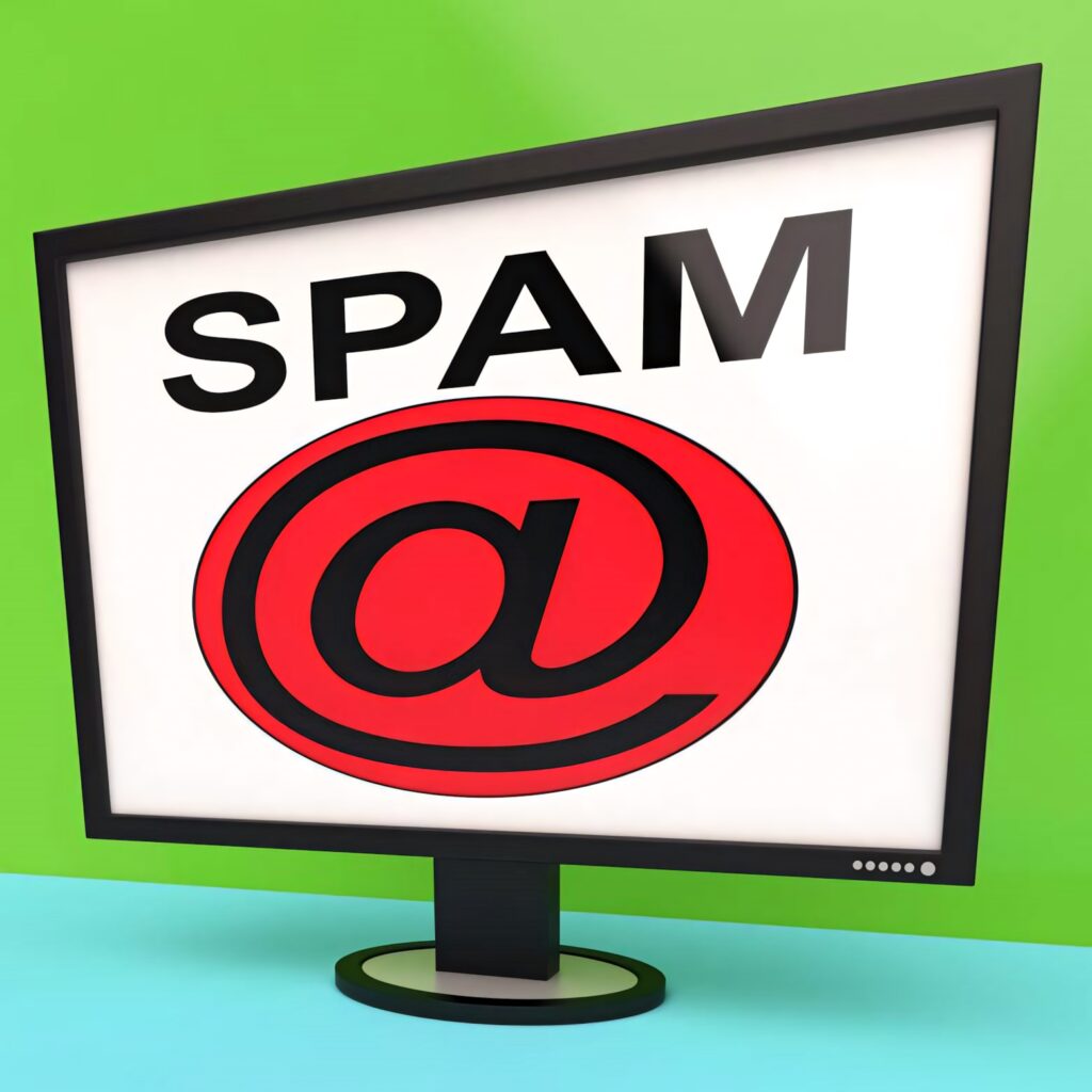 Computer monitor showing spam word above red email icon on green and blue digital background Wallpaper