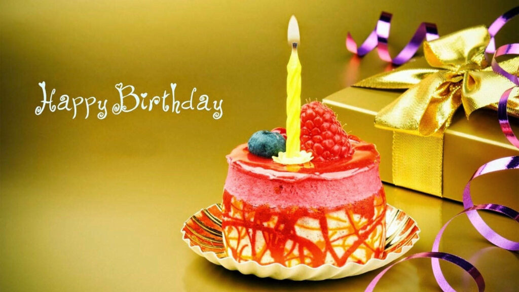 A Luxurious Birthday Cake with Berries and a Single Candle Wallpaper
