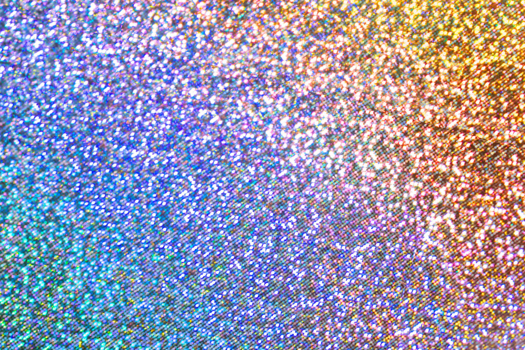 Retro blue glitter gradient wallpaper with vibrant multicolored shimmer and textured sparkle