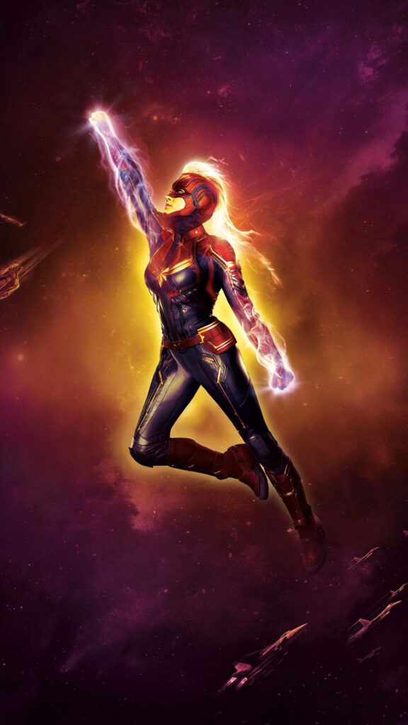 Captain Marvel's Majestic Flight Amidst a Cosmic Magenta Landscape with Spaceships Wallpaper