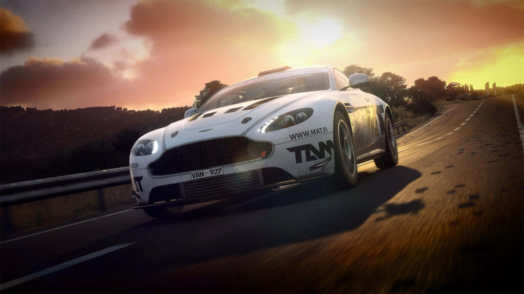 Dazzling Sunset Backdrop Enhances the Majestic Aston Martin V8 Vantage in a Dirt Rally Setting Wallpaper