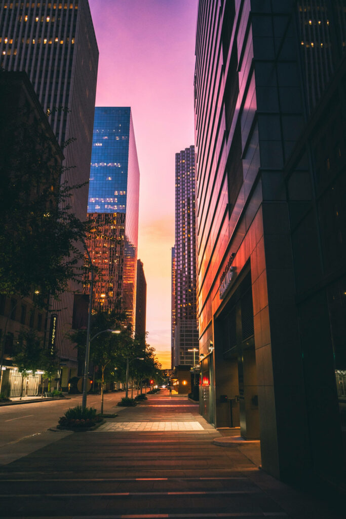 Twilight Majesty: The Captivating Glow of Skyscrapers Reflecting Vibrant Reds and Oranges - Scenic iPhone Background Wallpaper