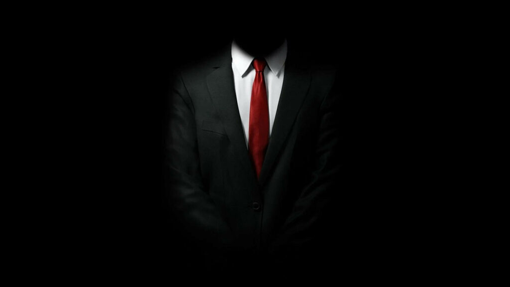 The Shadowed Operative: A Mysterious Figure Embracing the Void in Hitman 2018 Wallpaper