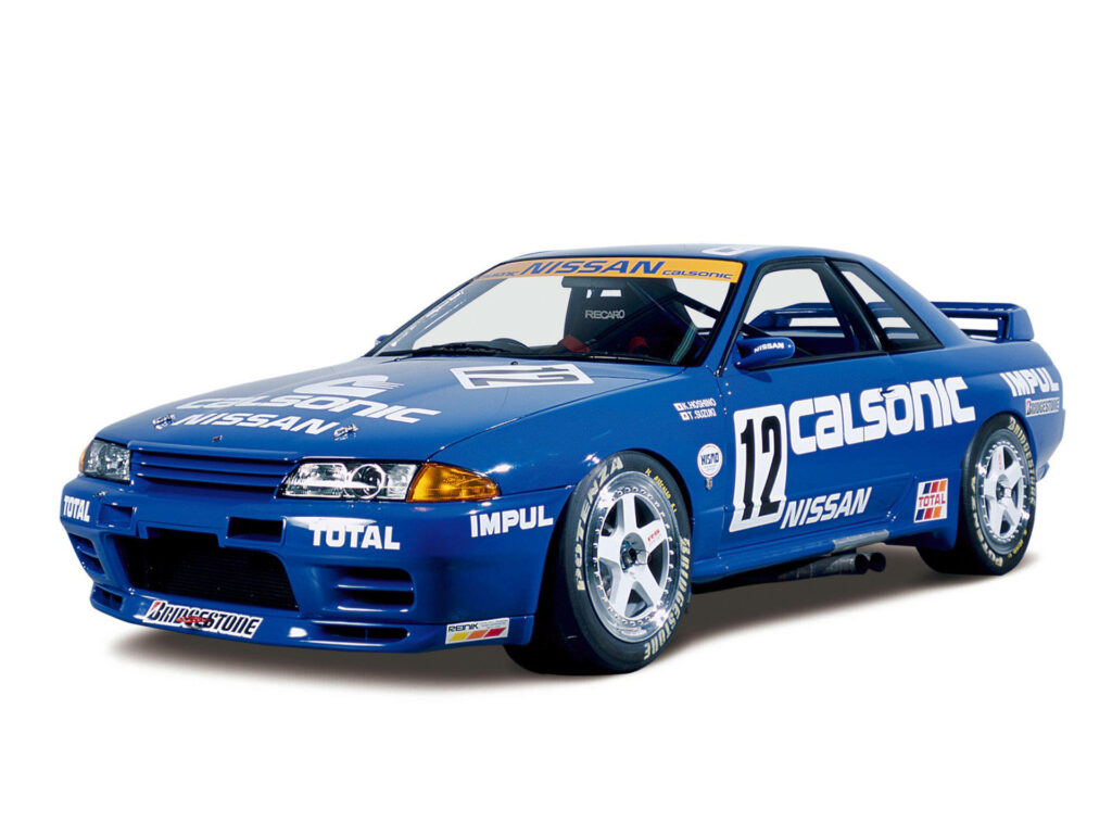 Speeding through the Skyline: A Blue Nissan Race Car Takes Center Stage against a White Wallpaper Background