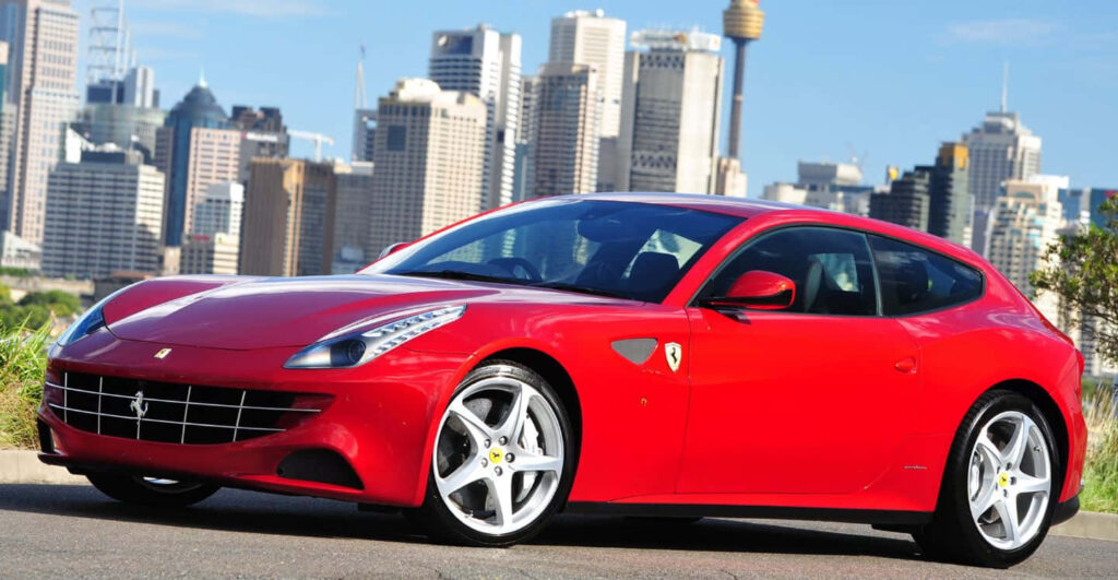 Captivating Speed: Embracing the Unbridled Elegance and Performance of a Striking Red Ferrari FF on an Open Road Wallpaper