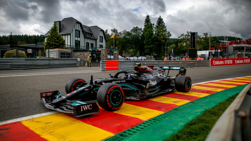 Mercedes AMG Petronas F1 car on Spa Francorchamps track with black livery and red yellow curbs Wallpaper