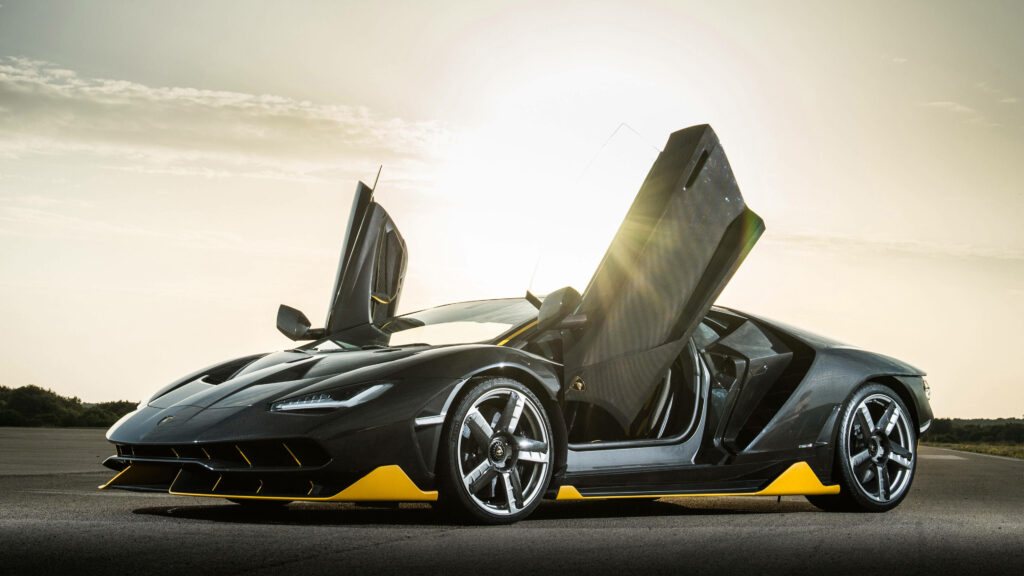 Exhilarating Lamborghini Centenario Unleashed: A Dynamic Black and Yellow Supercar Showcased in Striking Wallpaper