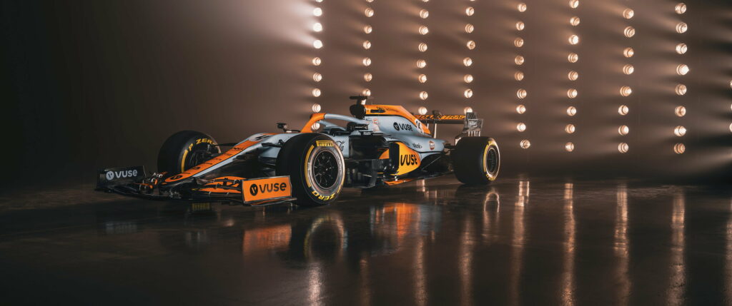 McLaren Formula 1 Racing Car in Striking Orange and Blue Livery - Lando Norris's Sleek and Aerodynamic Ride Wallpaper