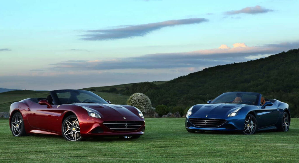 Unleashing the Power: Ferrari California T Tops Down, Racing Through a Majestic Highway Wallpaper