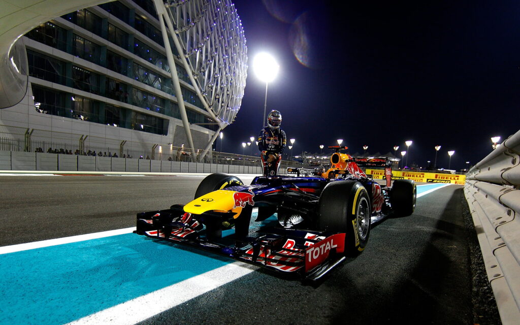 Nighttime Thrills: Racing towards Victory with Red Bull's Formula One Driver under the Glittering Lights - HD wallpaper