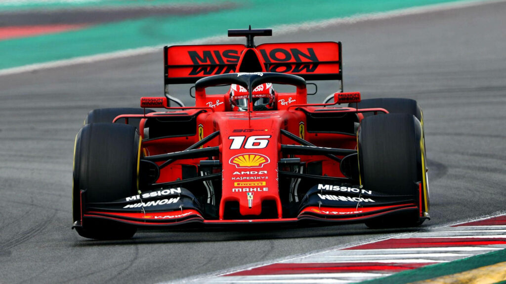 Roaring Towards Victory: Charles Leclerc Races Ahead in his Ferrari on the Track Wallpaper
