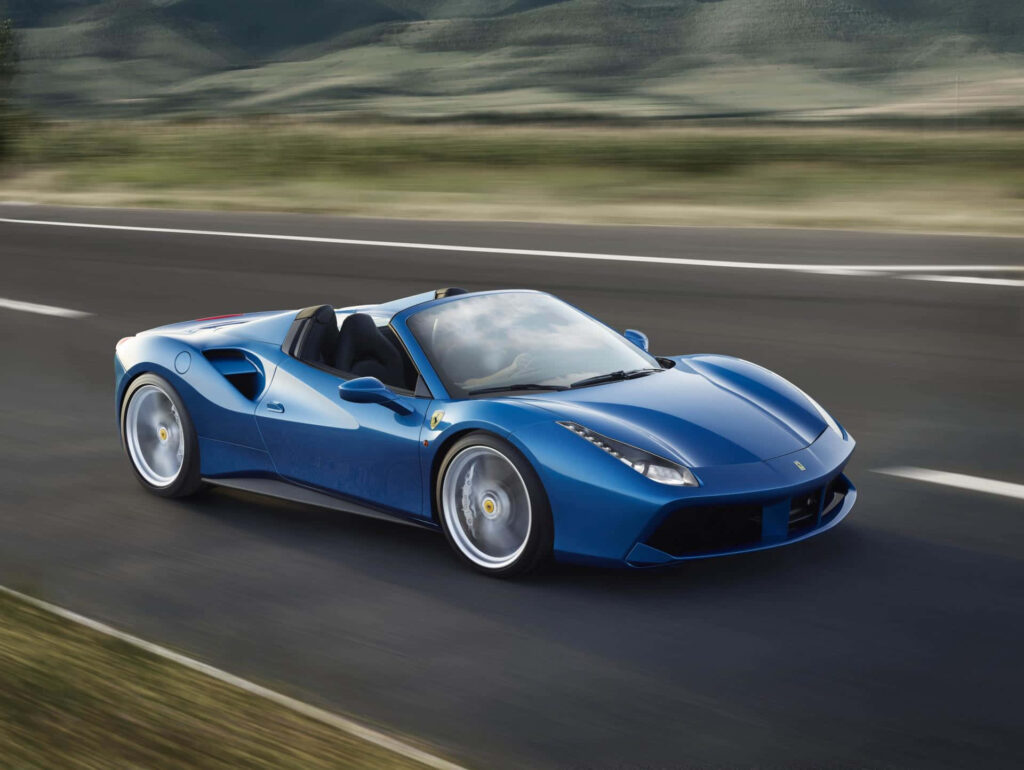 The Iconic Red Ferrari 488 Spider: A Majestic Display of Speed and Elegance against a Breathtaking Landscape Wallpaper