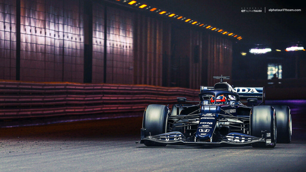 Thrilling Speed: Dark Blue F1 Race Car in a Stunning Cool Background Wallpaper