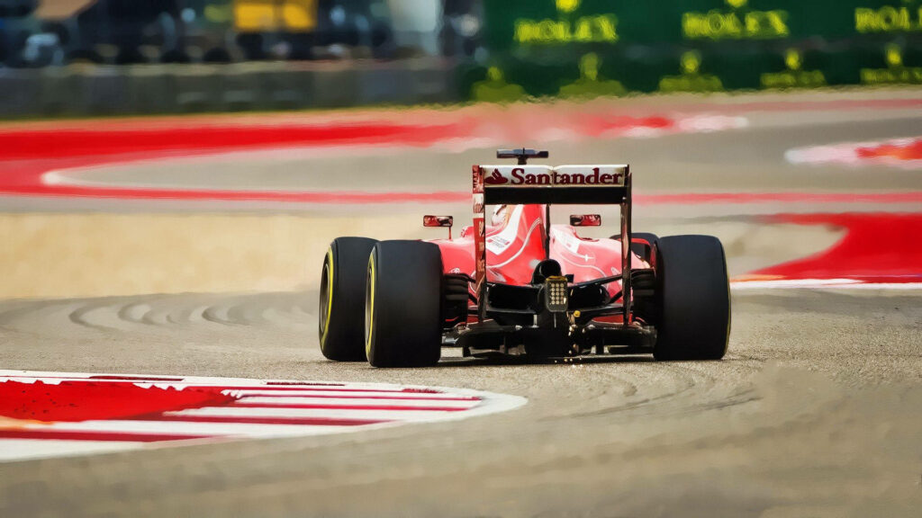The Speed Demon: A Thrilling Ferrari F1 Racer Braving a Sharp Bend in a Blaze of Red Wallpaper