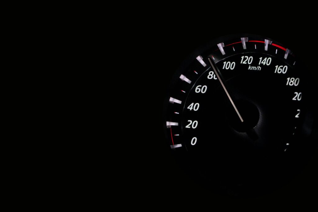Dynamic Speedometer Close-Up Wallpaper on Dark Background