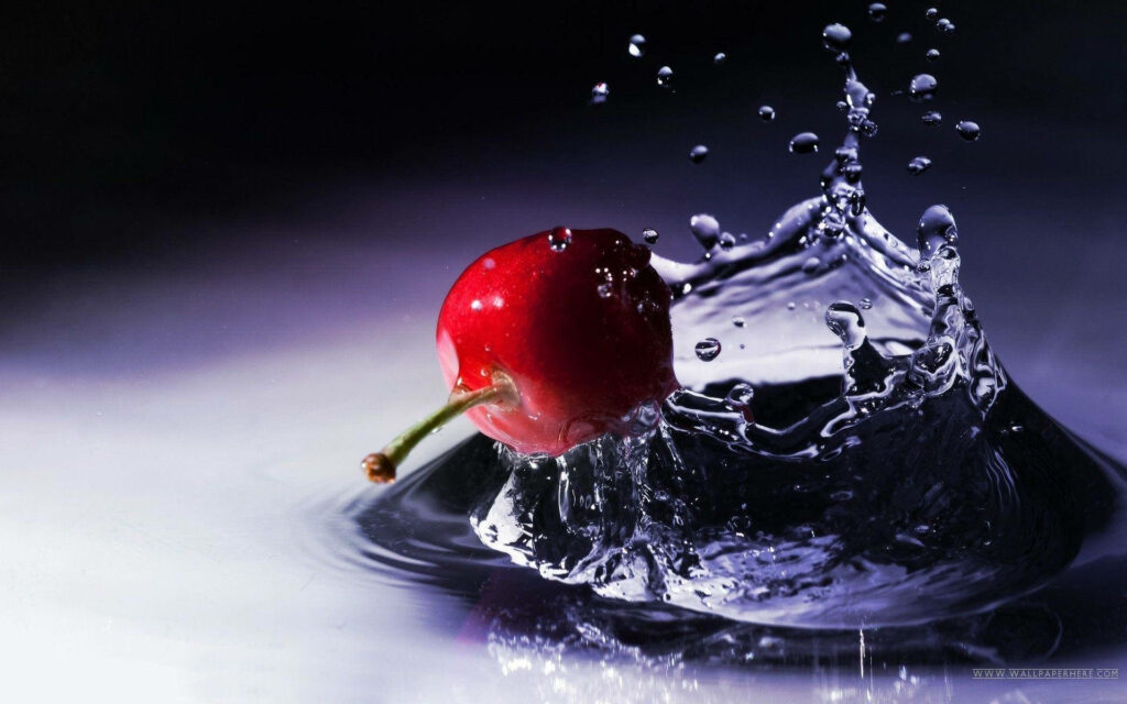 Splashing Spectacle: Mesmerizing Cherry Dive into Watery Canvas Wallpaper