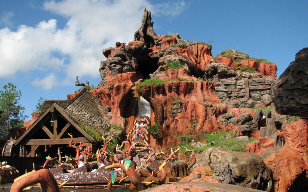 Splash Mountain log flume ride descending red-rock mountain under bright blue sky wallpaper