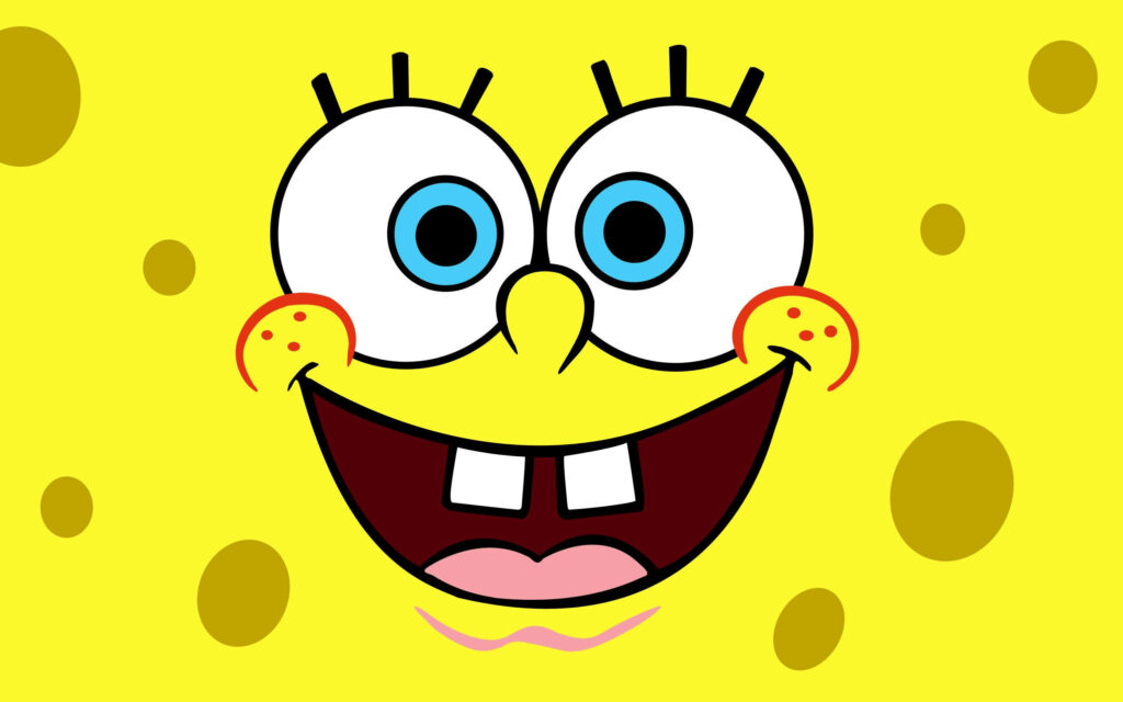 Vibrant SpongeBob SquarePants close-up wallpaper with cheerful smile and bright yellow texture