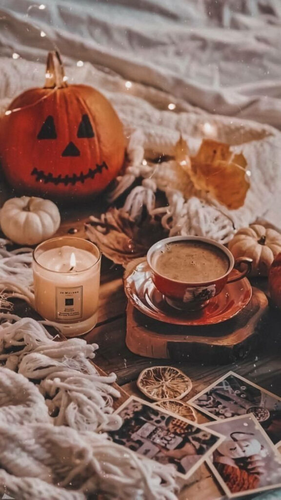 Cozy and Sparkling Halloween Vibes: A Charming Coffee and Jack O' Lantern Still-life Wallpaper