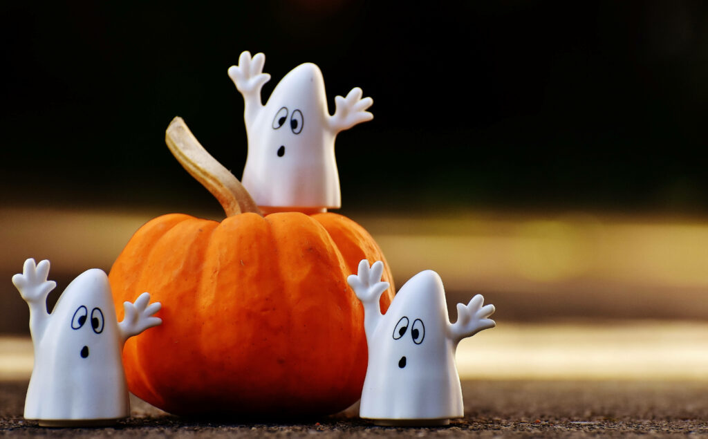 Halloween Haunts: Adorable Ghost Decor on a Pumpkin Perch Wallpaper