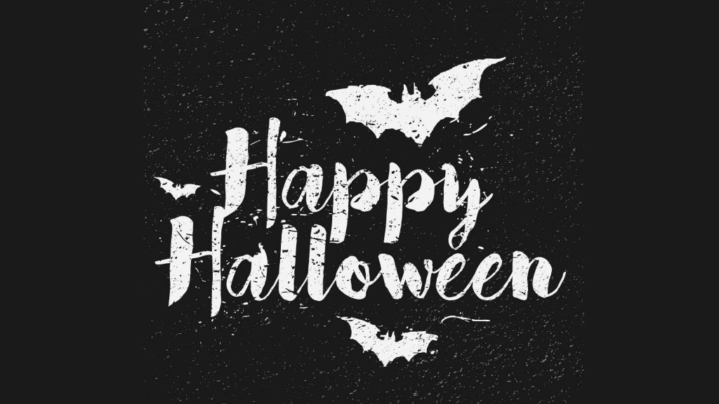 Happy Halloween wallpaper with distressed white text and bat silhouettes on dark background