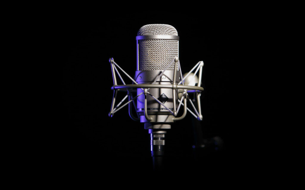 The Spotlight Shines on a Professional Microphone: Capturing the Essence of Live Performances, Podcasting, and Recording Studios Wallpaper