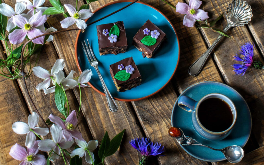 Springtime Temptations: Indulging in a Rainbow of Delightful Desserts Surrounded by Blooming Beauty Wallpaper